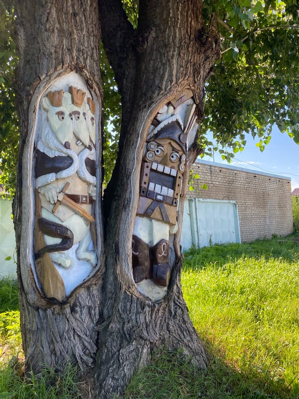 Folk carvings, street murals, and garden flowers in Chaikovsky