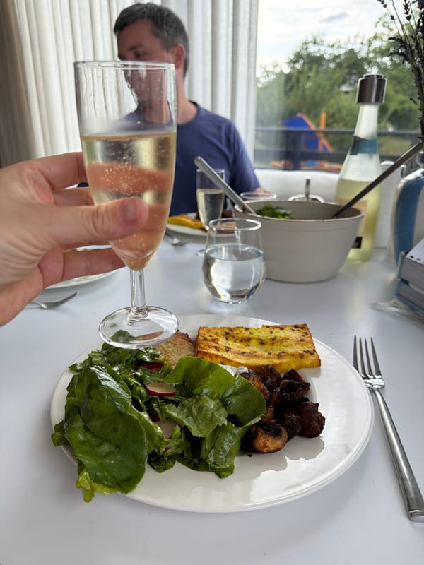 Champagne and a plated meal at a Gangloff table