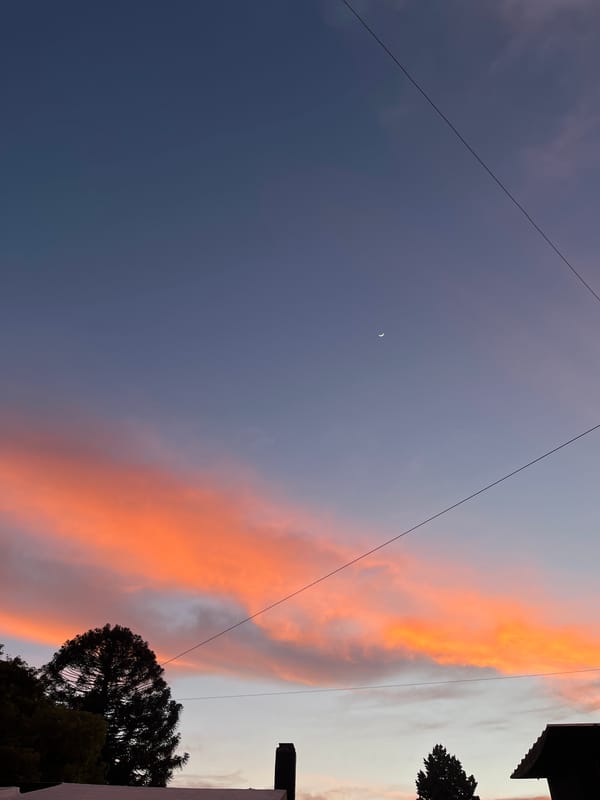 Crescent moon spotted over Cordoba residential area at twilight