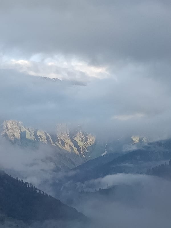 Vashisht in the clouds: mountains, fog, and a swollen river