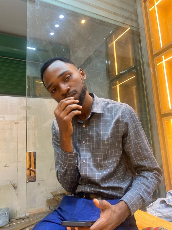 Man uses smartphone at indoor venue in Dar es-Salaam