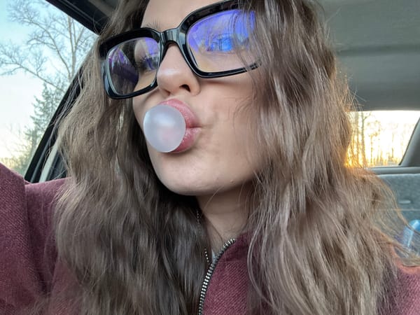 Person with glasses photographed blowing something in Rusalevka