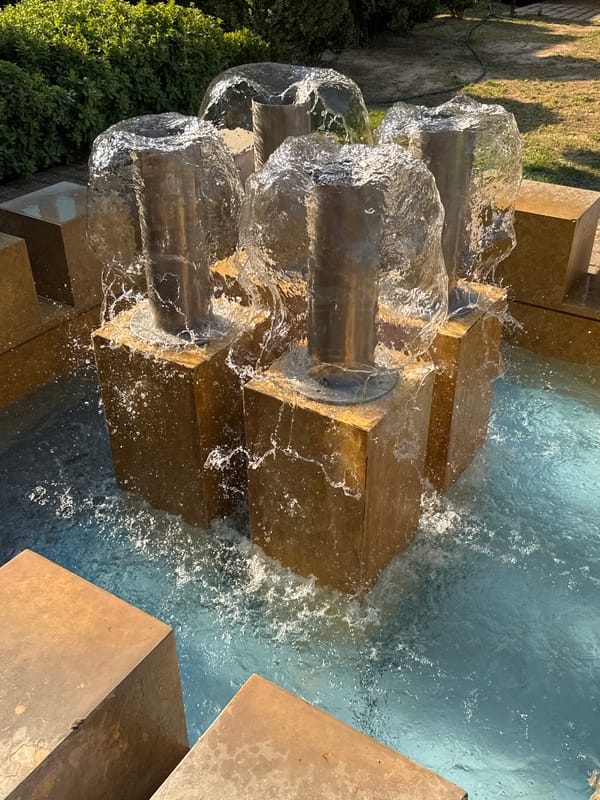Fountains and flowering plants in a Dafni public space