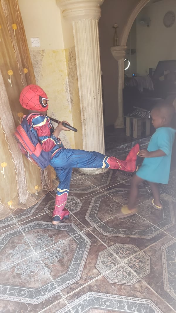 Child plays Spider-Man in Nigerian home with toys