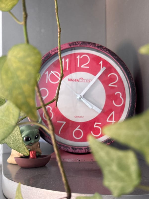 Clocks, watermelon, and Podgorica rooftops on a summer morning
