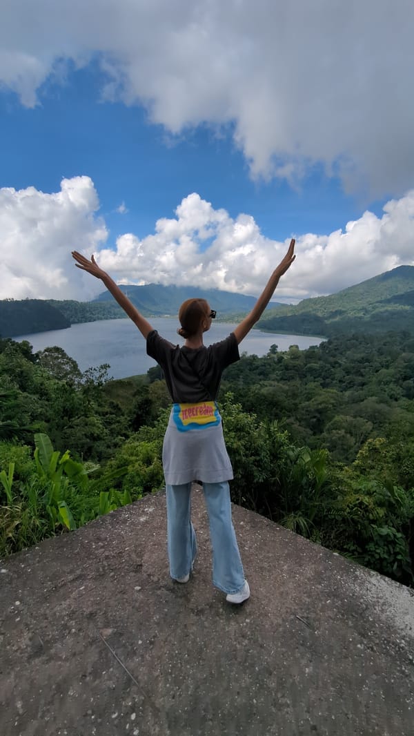 Woman enjoys scenic mountain lake view in Banjar, Indonesia