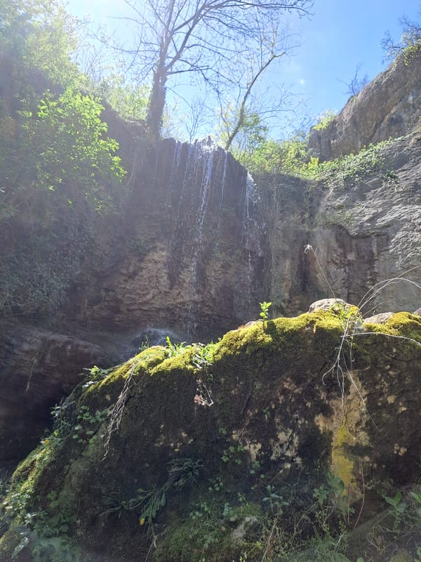 Waterfall observed cascading down rocky cliff in Veliko Tarnovo