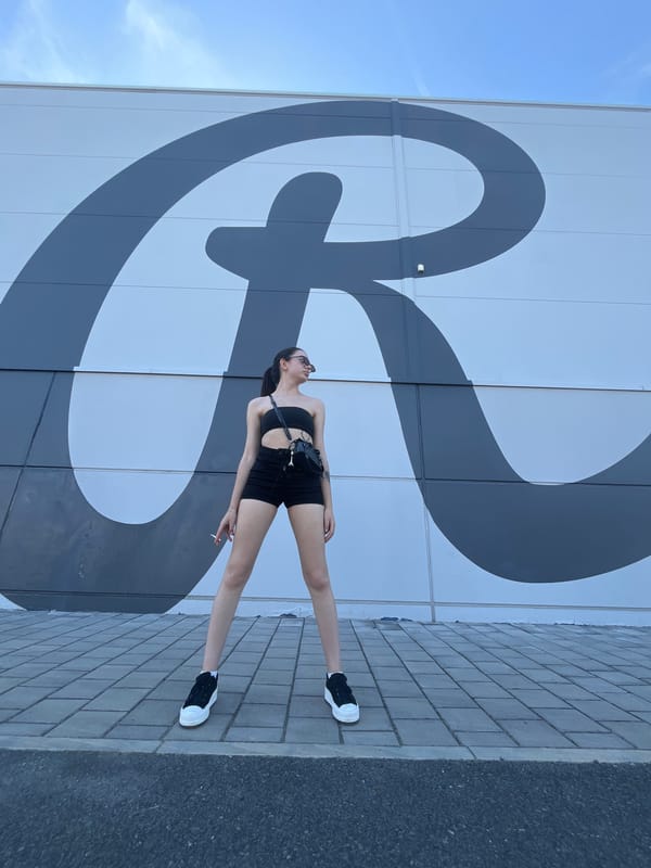 Posing against Pilsen's bold 'R' mural in all-black