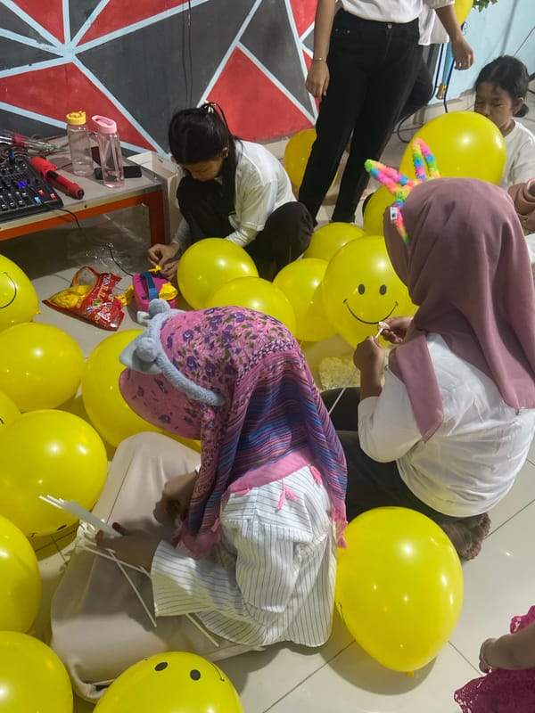 Balloon-decorated community hall gathering in Tanjung Gading