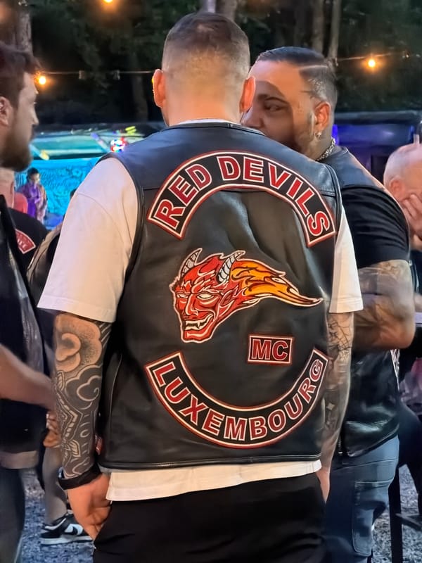 Motorcycle club crowd at an outdoor dusk concert in Luxembourg