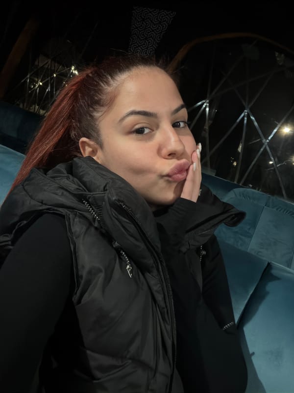 Woman makes kissing gesture in early morning Sofia