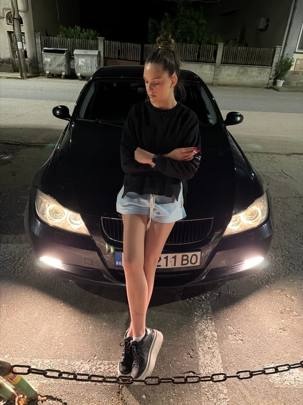 Woman poses on BMW hood in Kaleytsa, Bulgaria