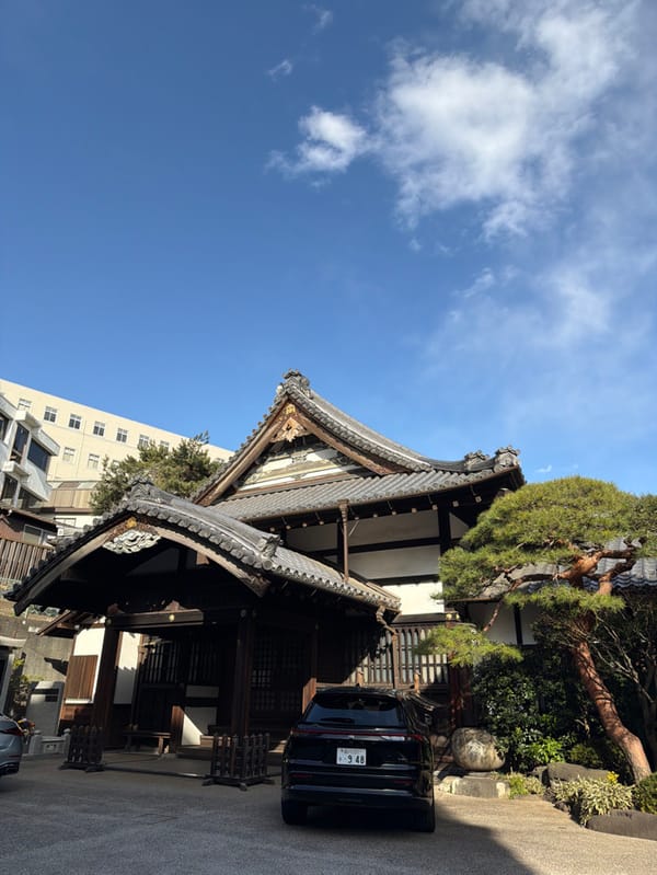 Traditional temple stands amid modern Shibuya streetscape