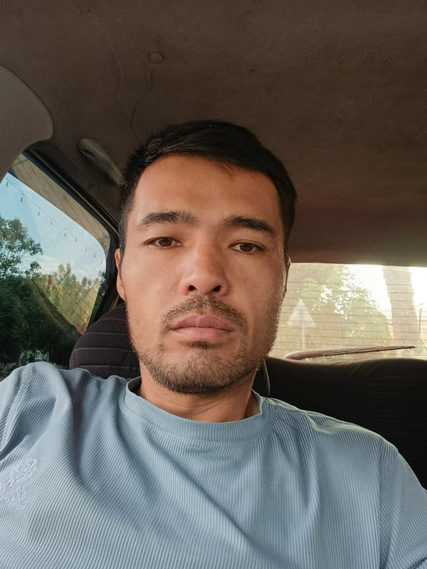 Man photographed in car portrait in Uzbekistan