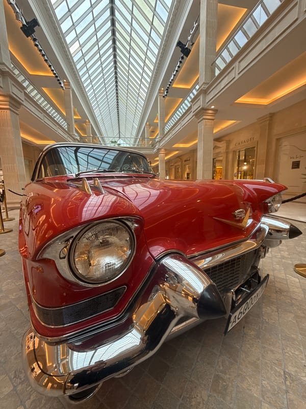 Red classic car parked indoors in Khimki, chrome details on display