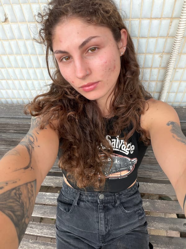Woman rests on bench in Kiryat Bialik