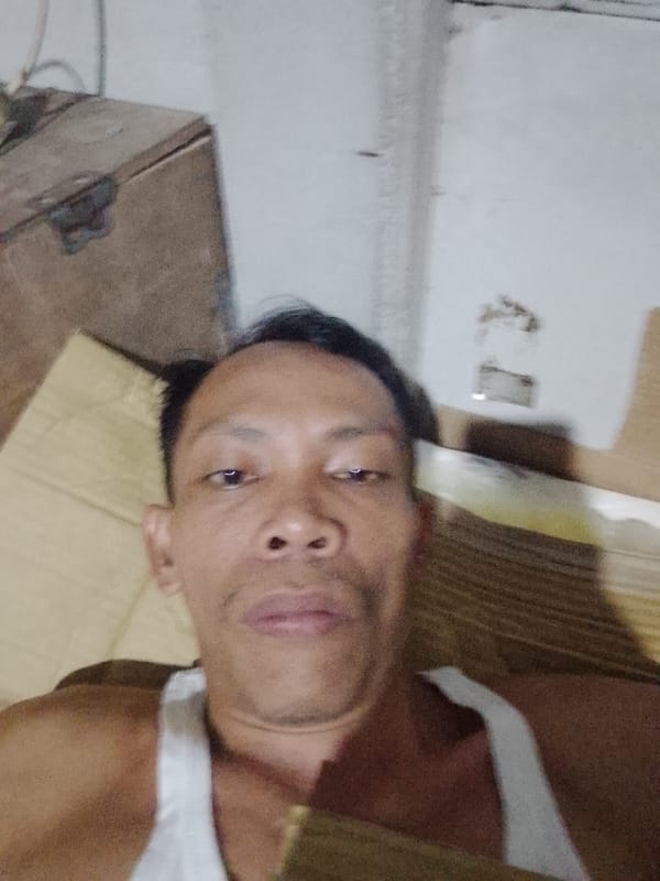 Man takes selfies indoors in Bukit Ketok, Indonesia