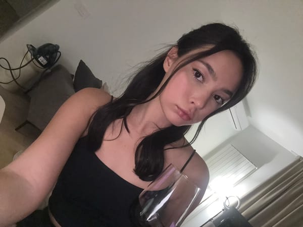 Woman takes indoor selfies with wine at home