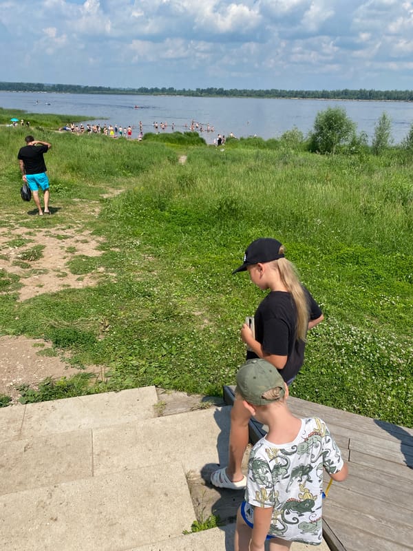 Summer day at a Russian riverside — swimming, strolling, and ships