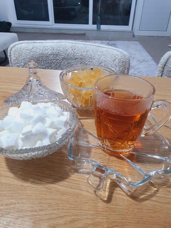 Home cook prepares spiced meal with tomato sauce and tea