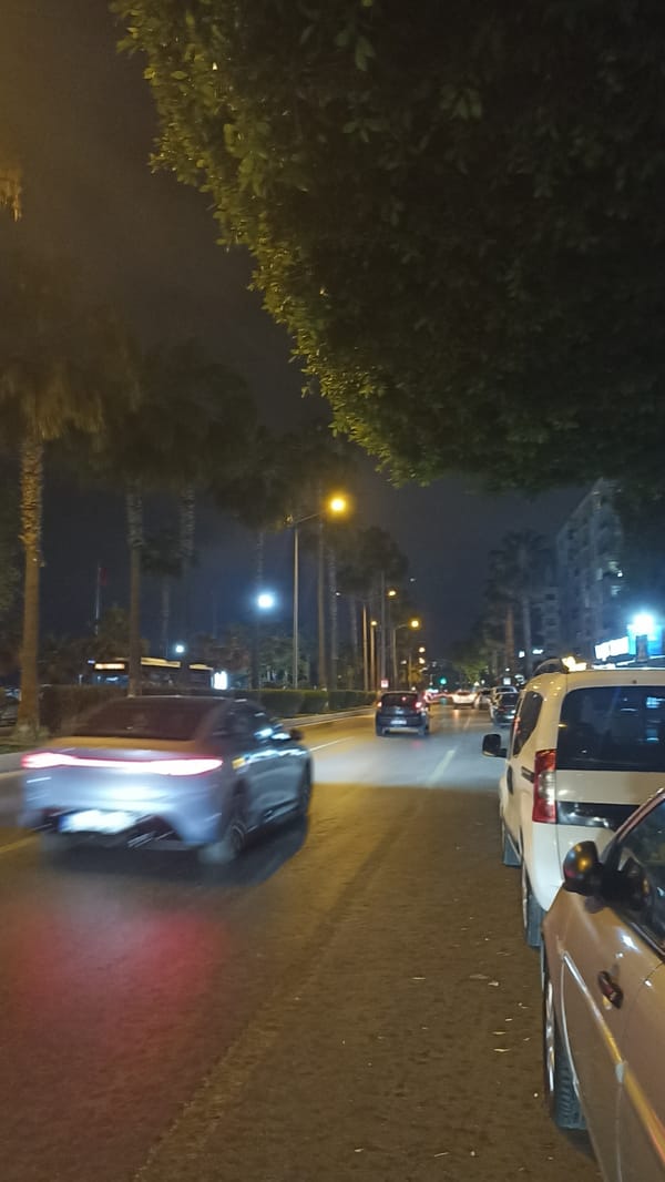 Evening stroll through illuminated Yenişehir streets and vintage portrait walls