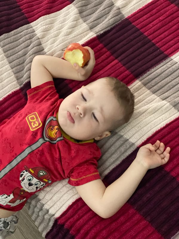 Child sleeps on checkered blanket in Sochi