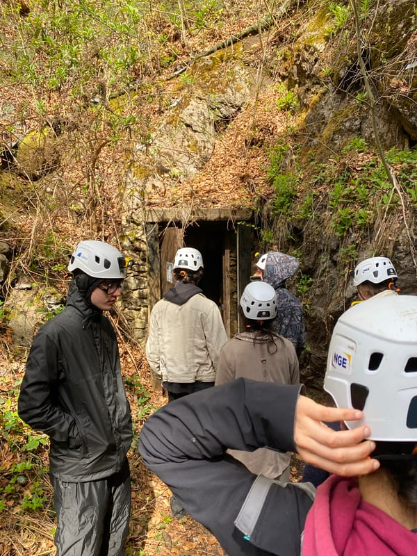 Group explores cave entrance in French Alps village