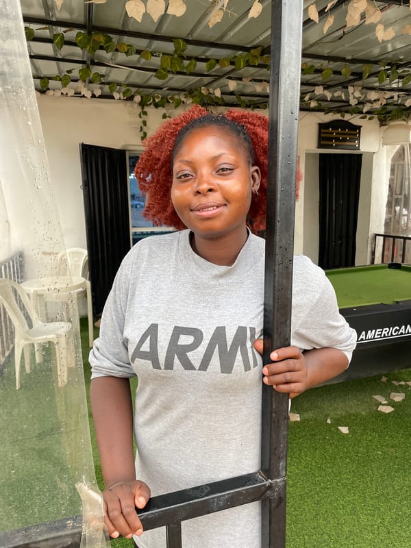 Woman in Army shirt photographed outdoors in Jos, Nigeria