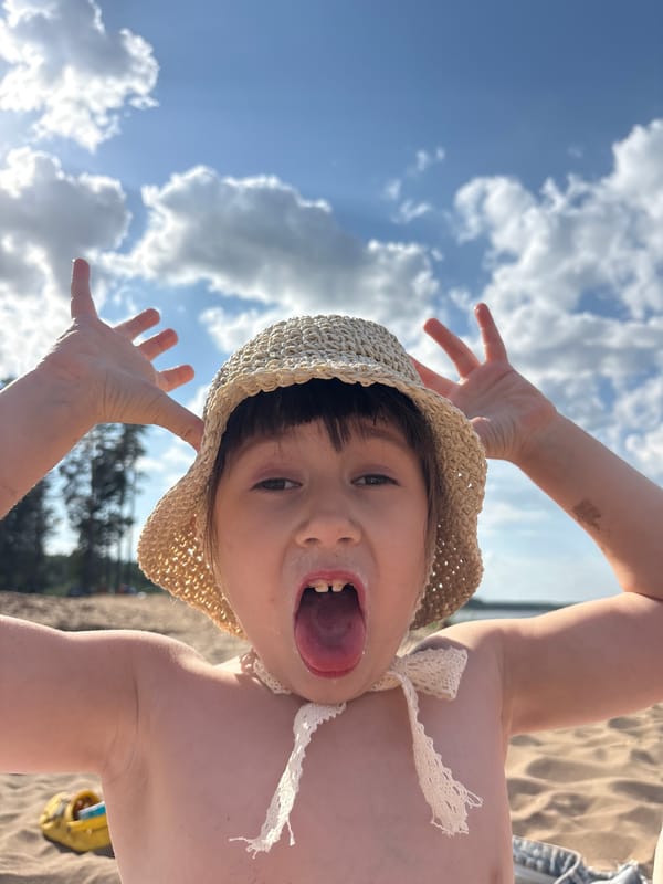 Child and dog enjoy beach day in Chaikovsky