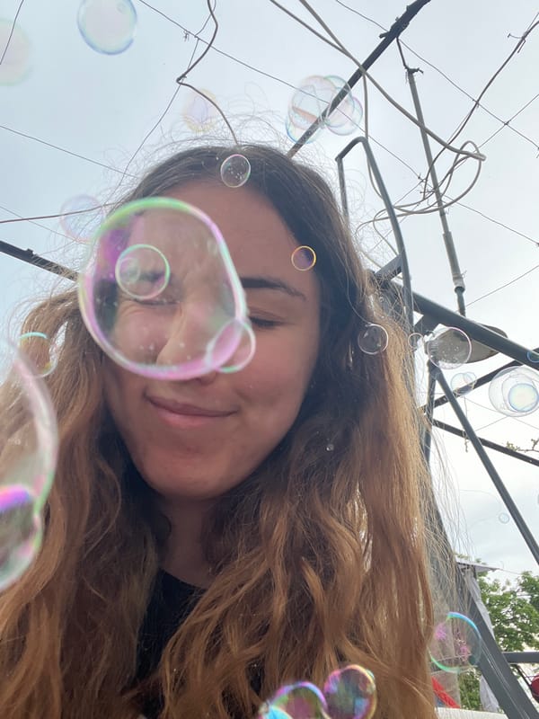 Woman, child play with bubbles, kittens in Burgas