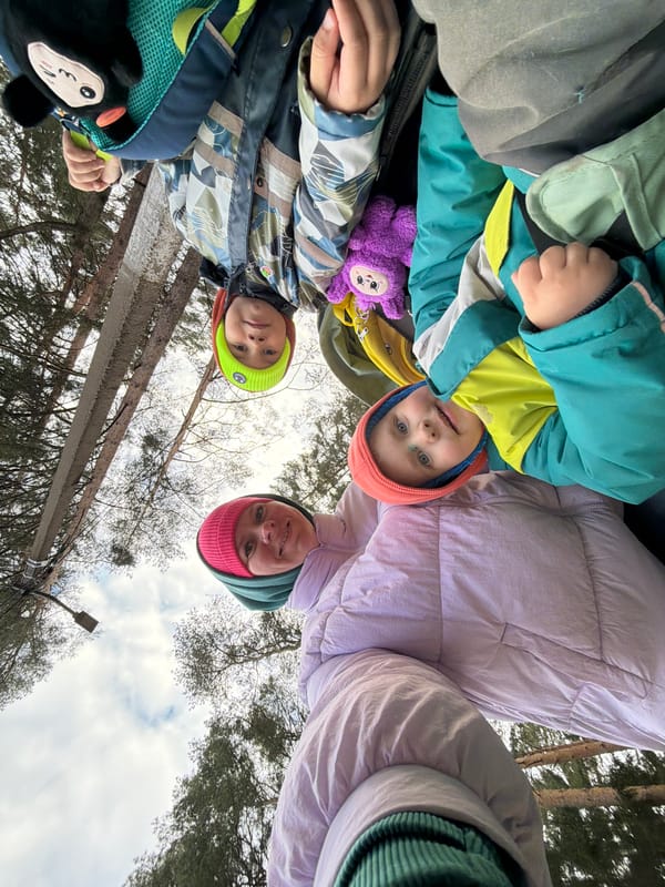 Family moment captured near wooded waterside in Chaikovsky, Russia