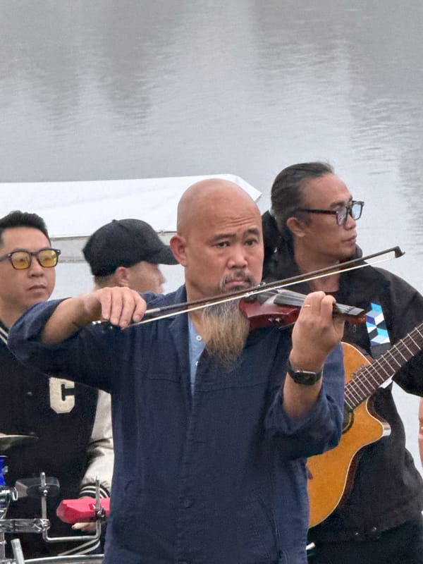 Live band plays lakeside in Da Lat on a grey evening