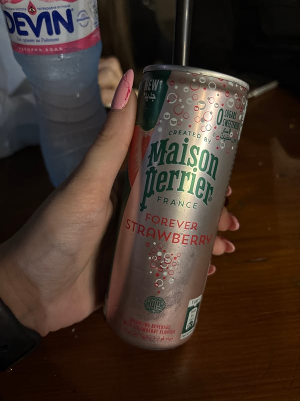 Person holds sparkling drink and water in Bulgarian town