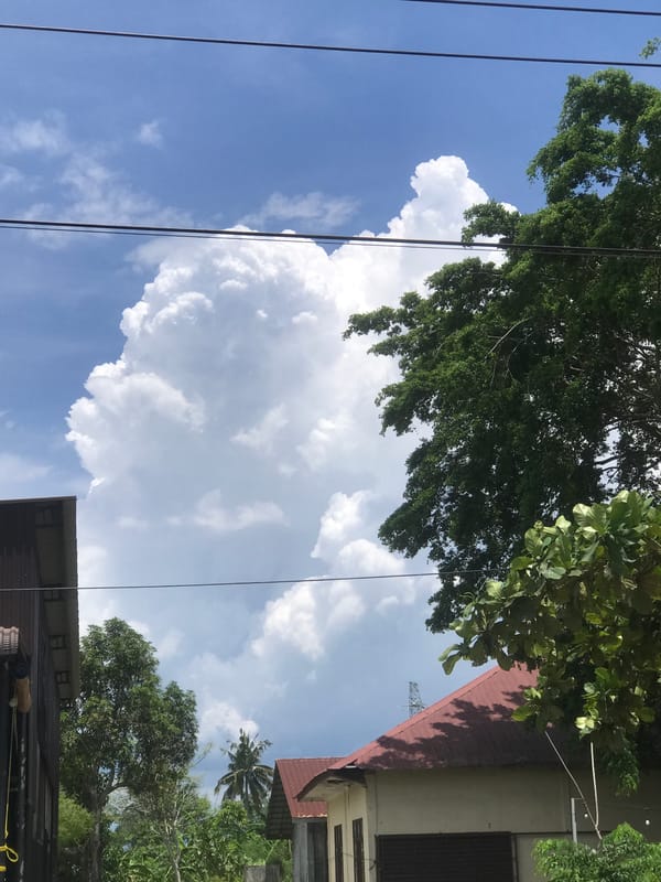Morning street scenes documented in Lhokseumawe under storm clouds