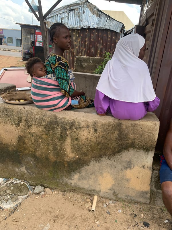 Resting at a concrete ledge in Adankolo, Nigeria