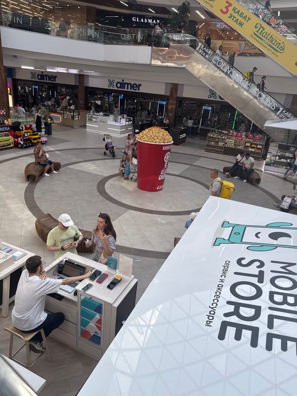 Inside Dostyo Mall, Petropavl — retail floors and storefronts