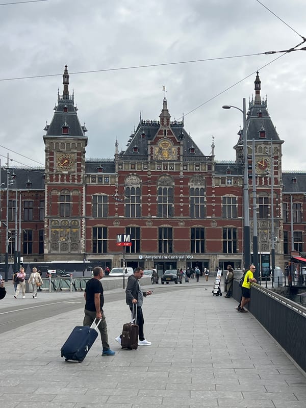 Amsterdam Centraal and canal boats on a June morning