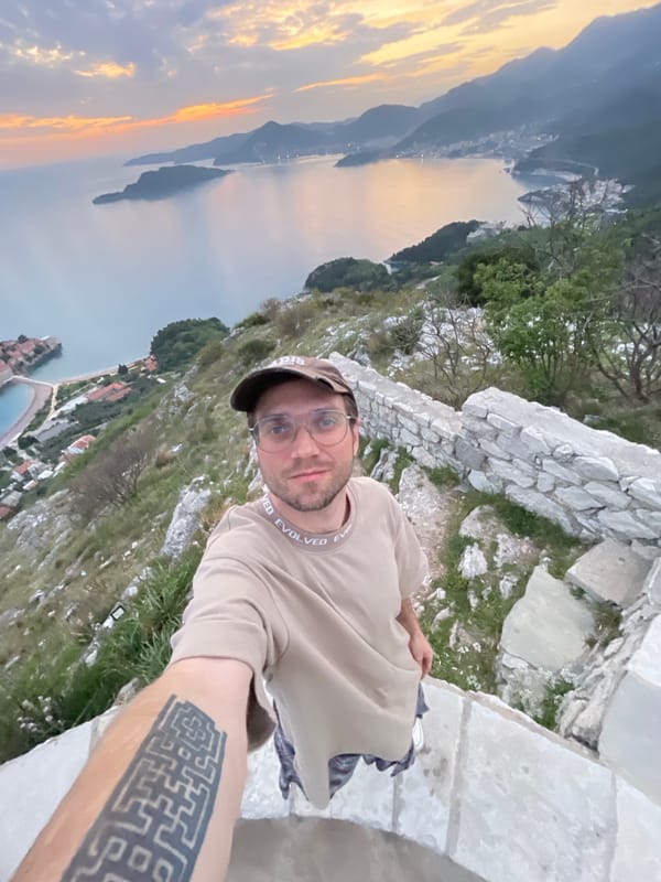 Tourist takes selfie at Sveti Stefan viewpoint, Montenegro