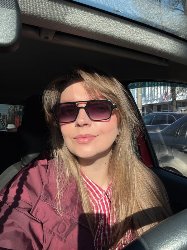 Woman photographed in car during sunny day in Izhevsk
