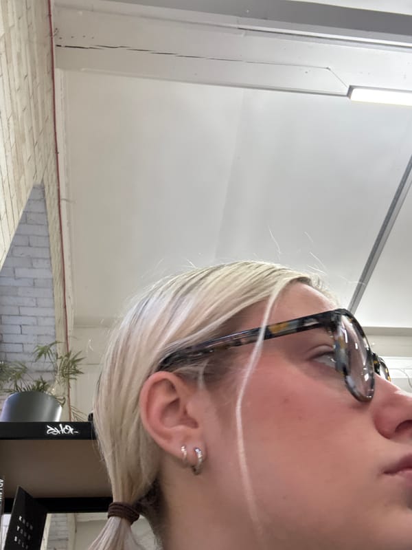 Person with glasses photographed from below in Manchester