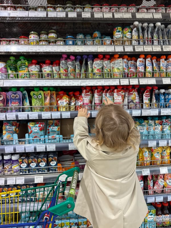 Child shops with toy cart in Moscow supermarket