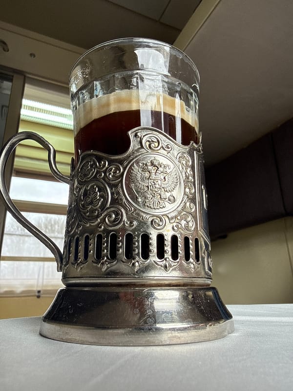 Traditional Russian podstakannik holds layered beverage in Vyglyadovka