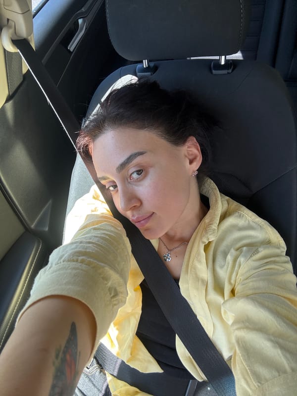 Woman in yellow shirt observed driving in Tbilisi