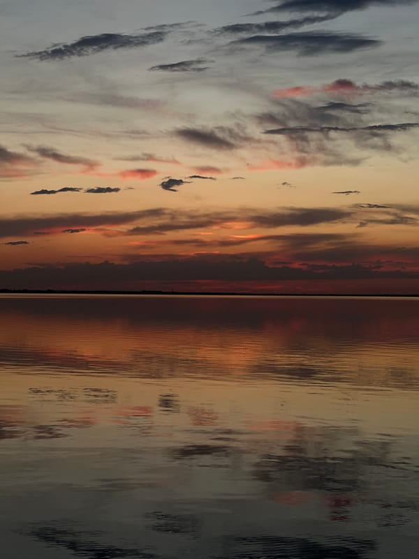 Sunset over Lake Kopa, Kazakhstan features aircraft and dramatic clouds
