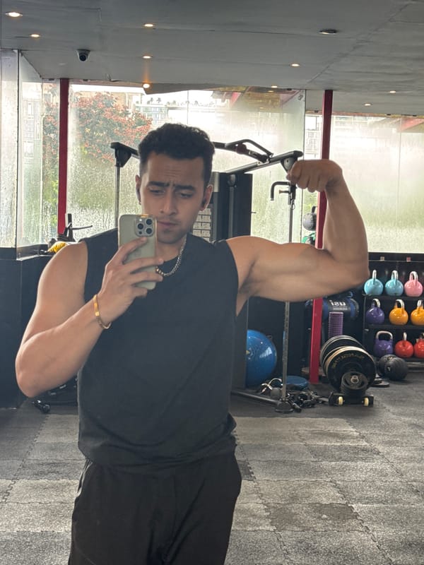 Gym selfie session in Kolkata, flexing and smiling.