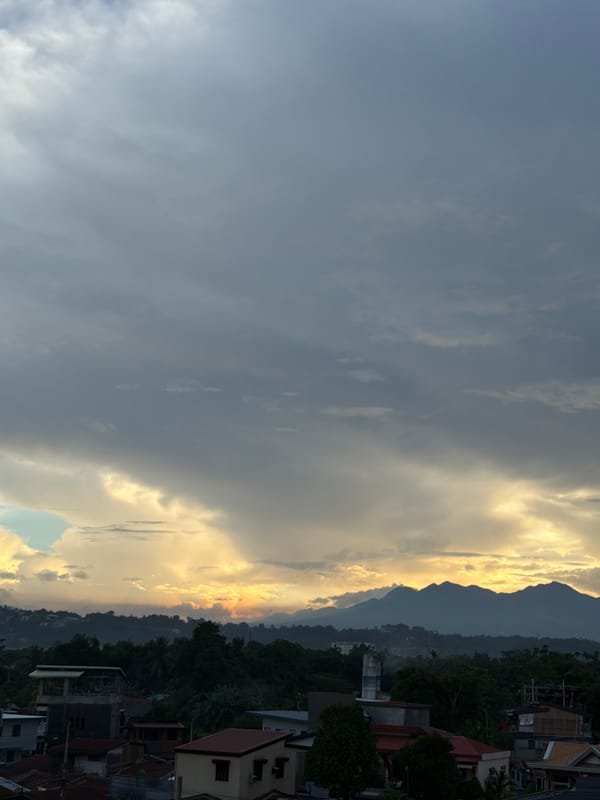 Dramatic sunrise over Davao City residential areas and Mount Apo