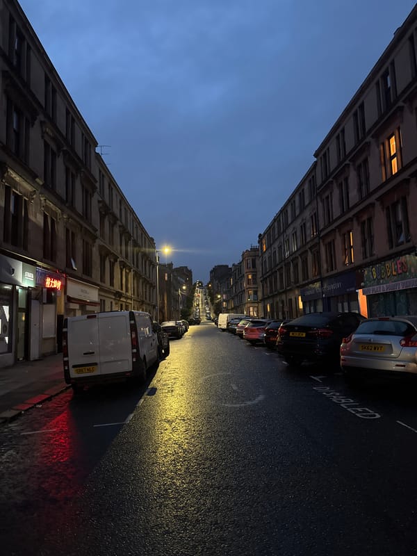 Glasgow tenement street at dusk, deep sky overhead