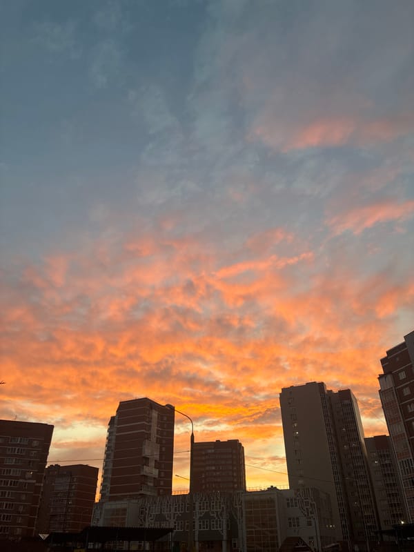 Vivid sunset colors illuminate urban sky during twilight hours