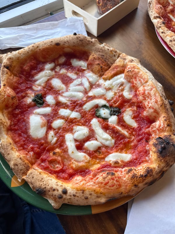 Margherita pizza captured on green plate in Cocoa Beach