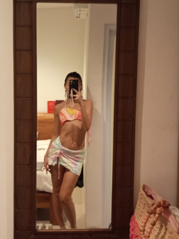 Woman takes mirror selfies in colorful outfit in North Kuta